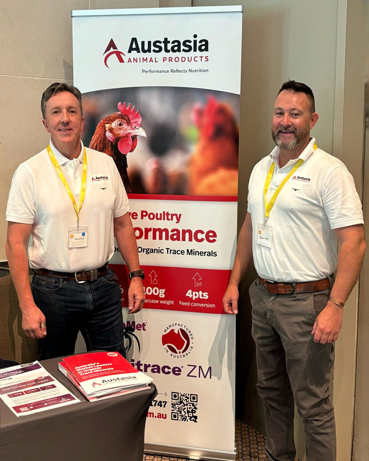 Austasia team members standing in front of Austasia poultry sign at the Australian Egg Industry Forum