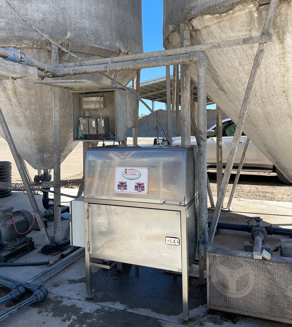 Austasia applicator system next to two silos